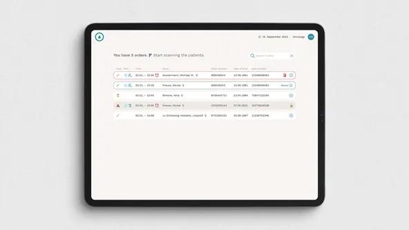 A tablet screen showing Tracie software with a list of patient sample orders, supporting automated and secure pre-analytical tracking.