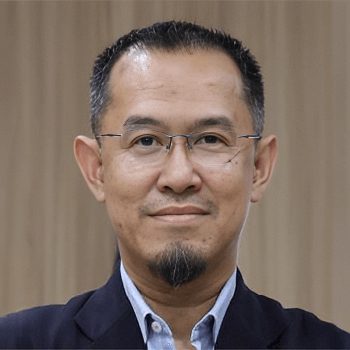 A professional headshot of Dr. Muhammed Anis Abd Wahab wearing glasses and a dark suit jacket.