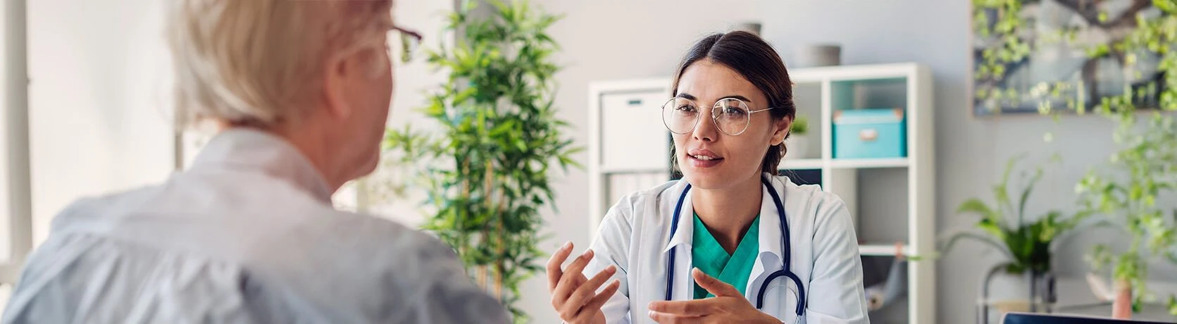 A female doctor in a meeting with a patient in an office.