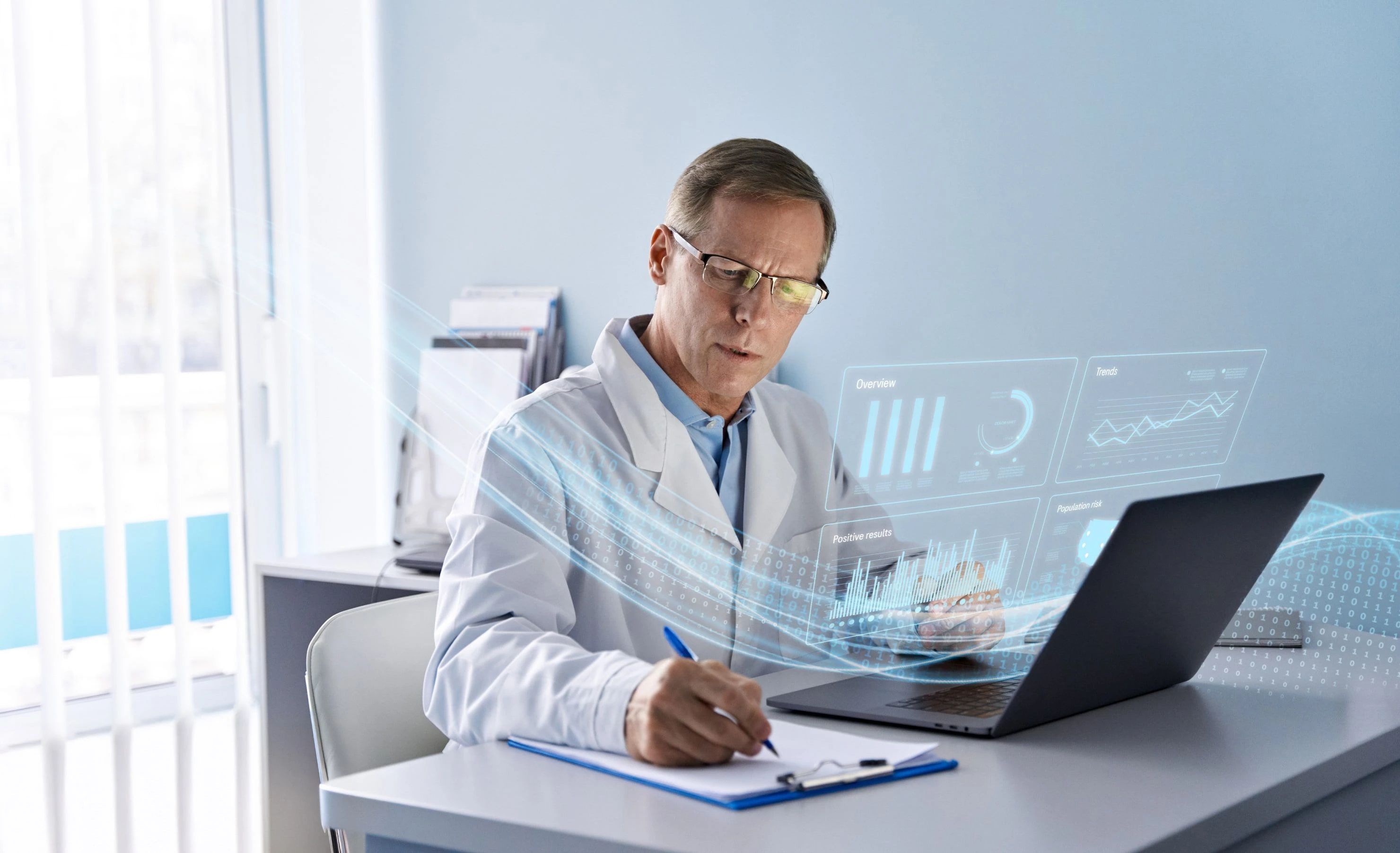 A healthcare professional reviews data charts at a desk while taking notes.