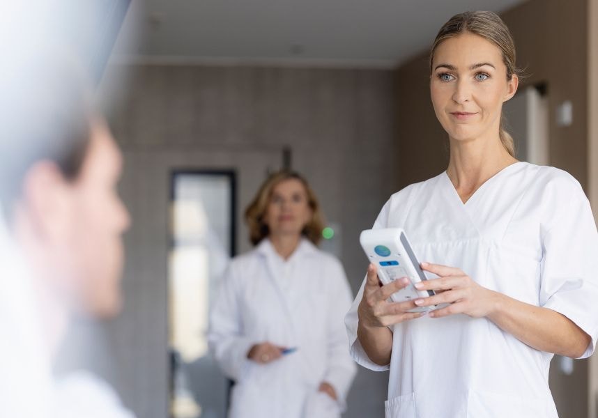Female doctor in hospital holding cobas® pulse.